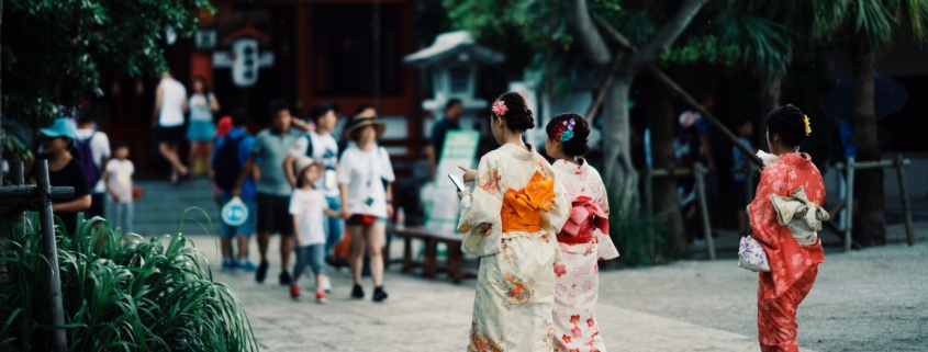 woman in white and red floral kimono walking on street during daytime